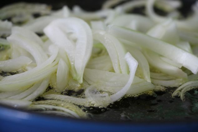 sliced onions sautéing 