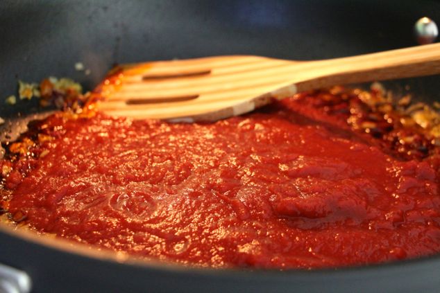 adding crushed tomatoes