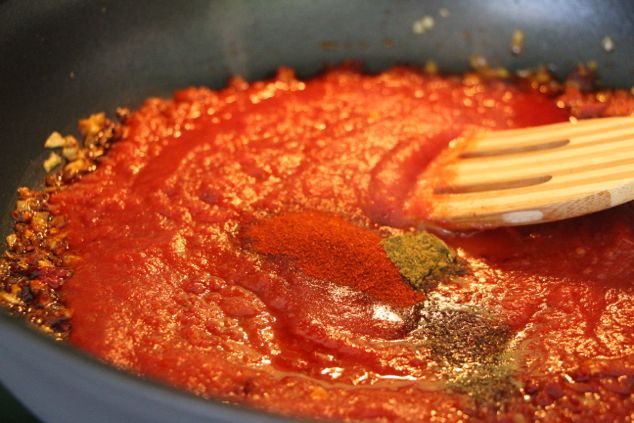 adding spices to sauce