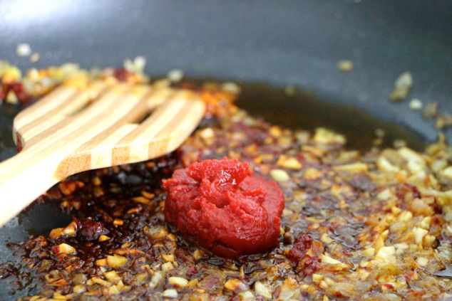 adding tomato paste