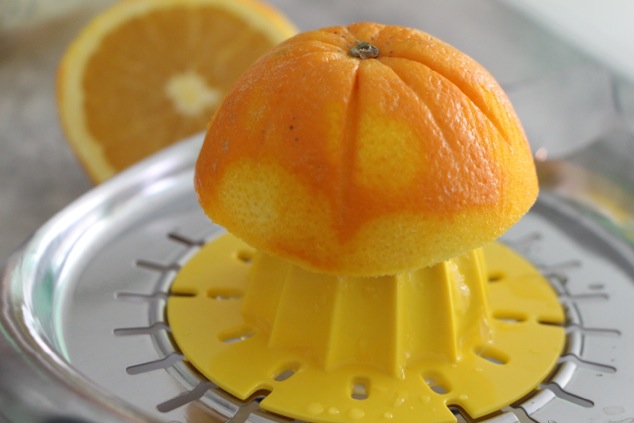 hand juicing an orange