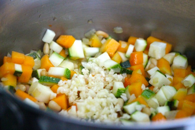 adding minced garlic to pot