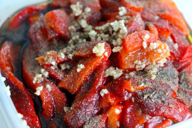 adding spices to roasted peppers