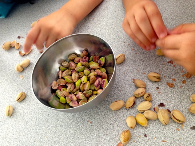 little hands peeling pistachios