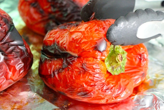roasted peppers out of oven with tongs