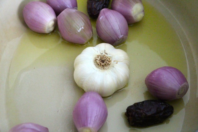 shallots garlic and dates in pot