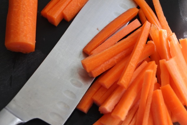 slicing carrots into strips