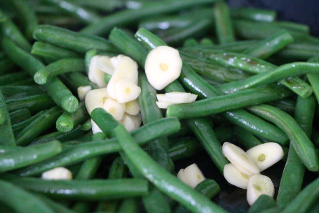 adding sliced garlic