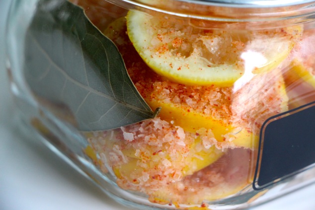 arranging slices of lemons in a jar up close