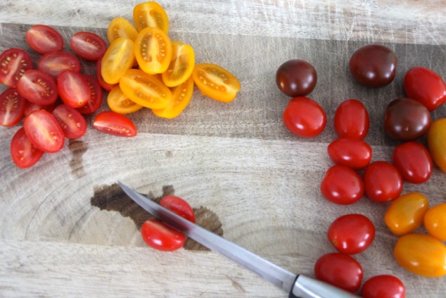 cutting cherry tomatoes in half