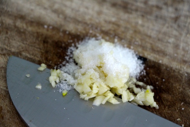 salt on chopped garlic