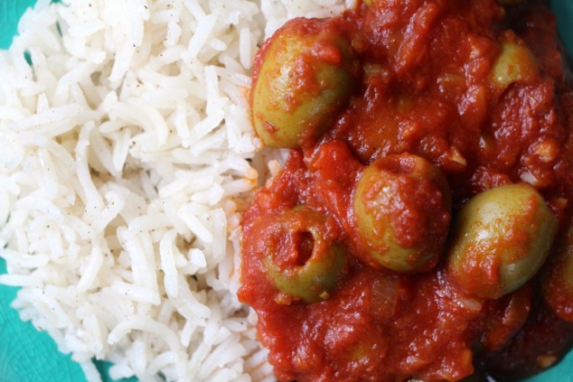 green olives and tomato sauce served with rice up close