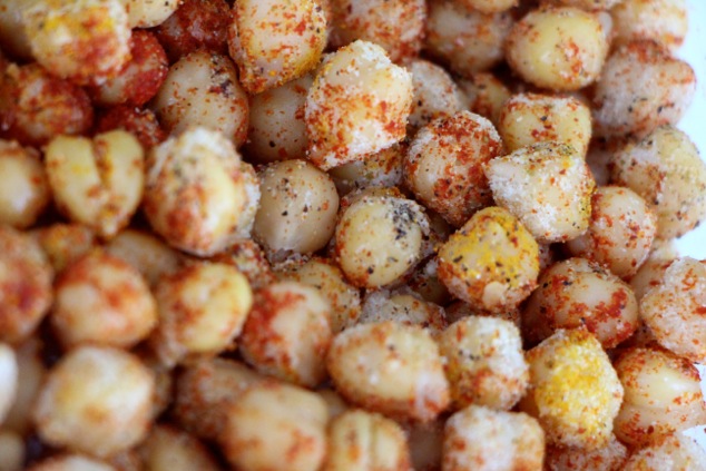 coating chickpeas with spices up close