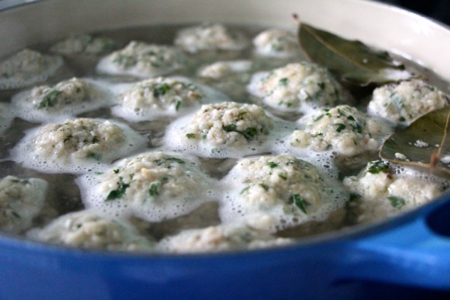 matzo balls dropped into a pot of water