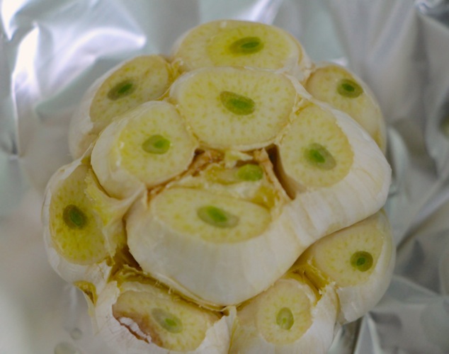 a head of garlic in aluminum foil