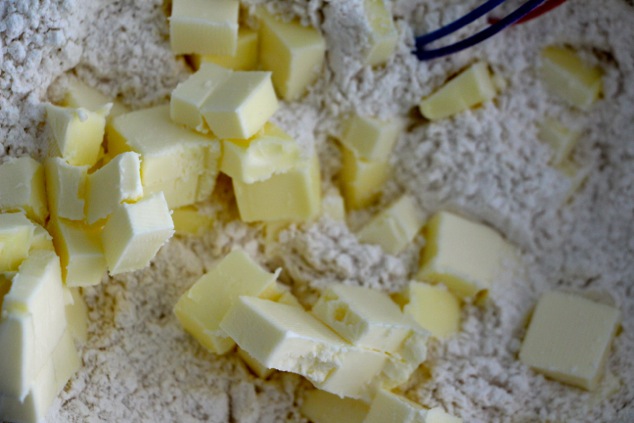 blending butter cubes into flour