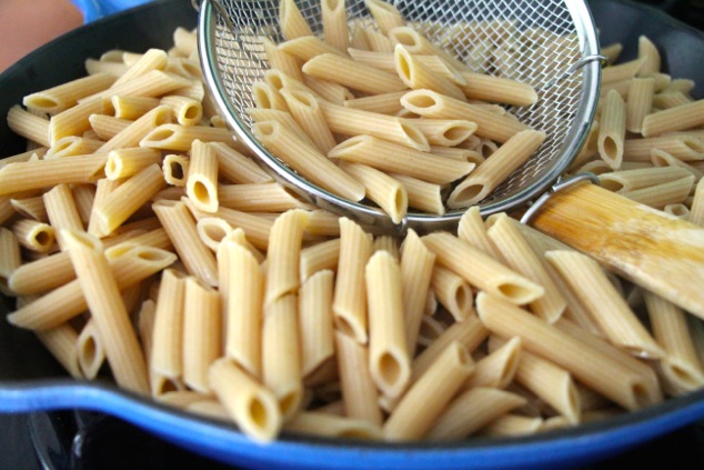 adding cooked pasta to pan