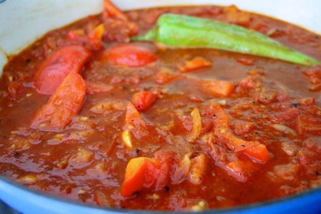 adding crushed tomatoes and water