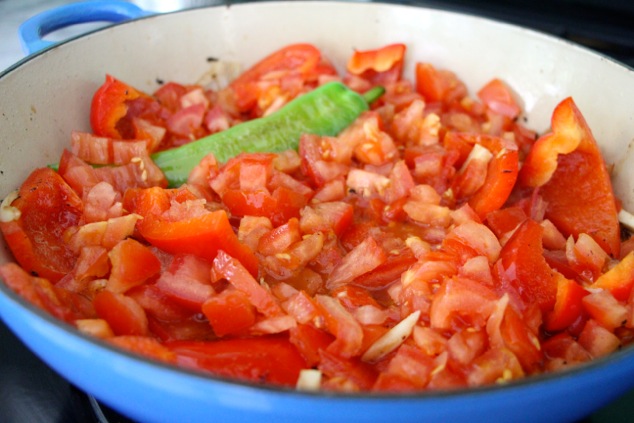 adding tomatoes to the pot