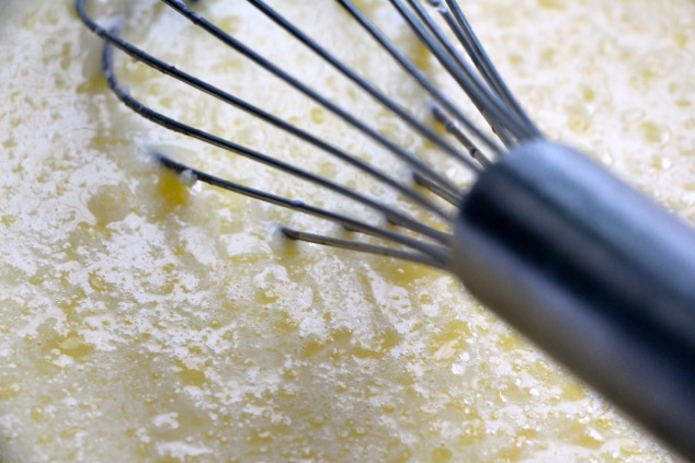 whisking melted butter in