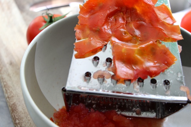 grating tomato in a grater box