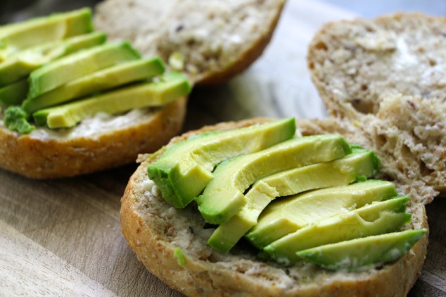 adding avocado onto sandwich