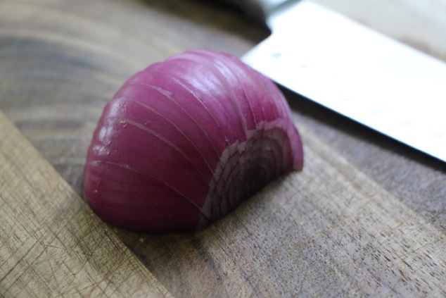 purple onion on cutting board