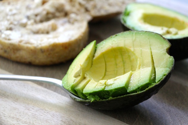 scooping avocado slices