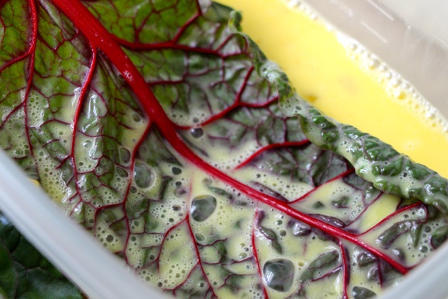 dipping swiss chard in egg