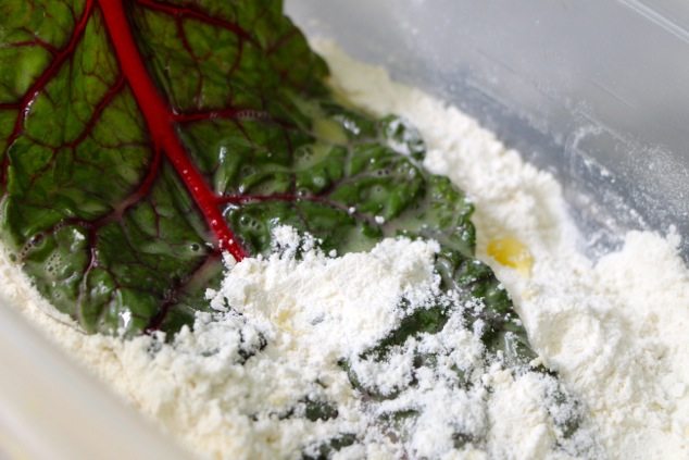 dipping swiss chard in flour