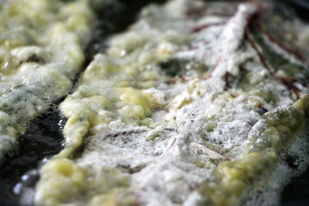 frying coated swiss chard up close
