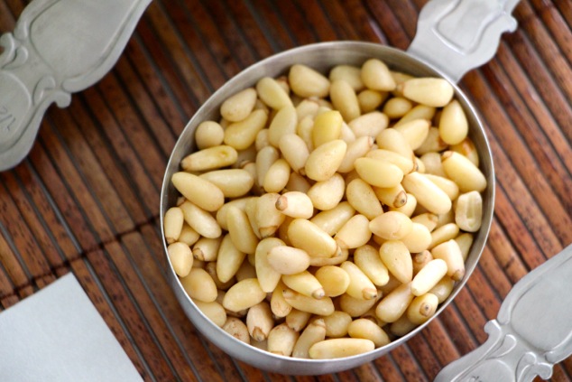 pine nuts in a measuring cup