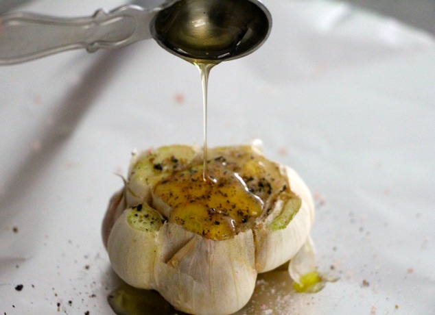 drizzling honey on garlic