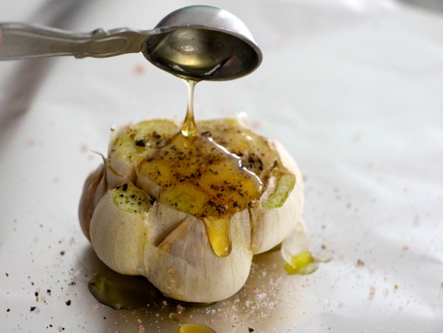 drizzling honey on garlic up close