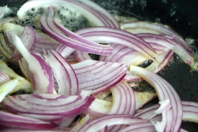 cooking sliced purple onion
