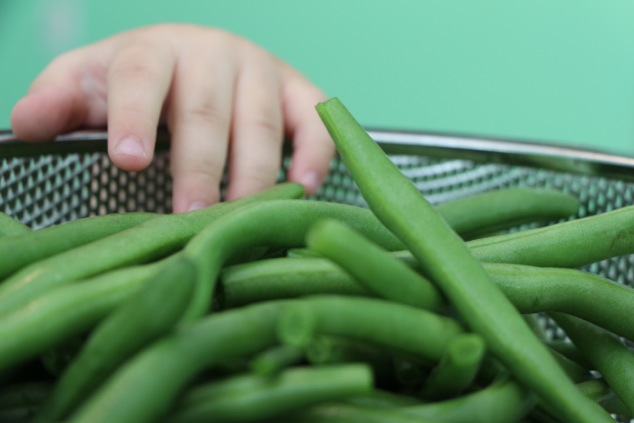 hand and green beans