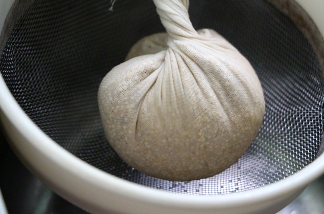 squeezing water out of quinoa in cheesecloth