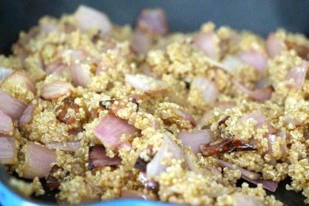 mixing cooked quinoa and onions