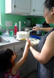 covering-birthday-cake-and-kid