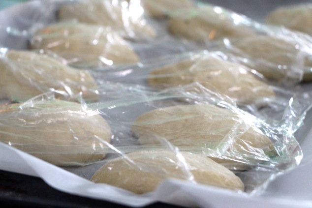 fricassee dough rolls on tray and covered