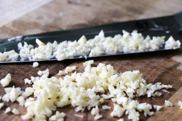 finely chopping garlic