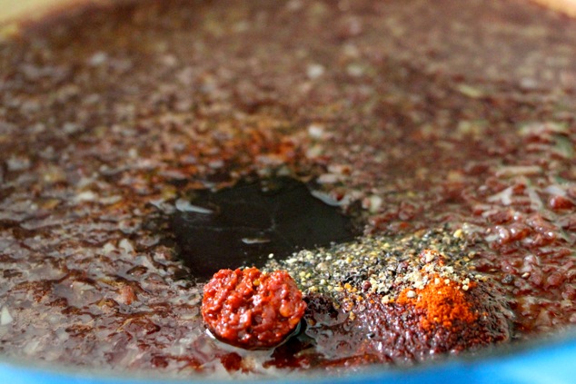 adding Harissa and spices to the sauce