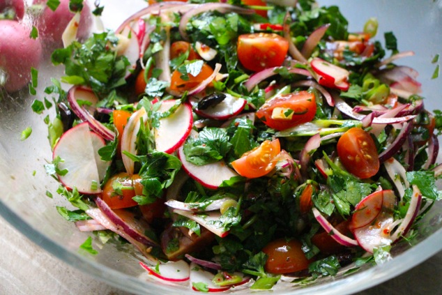 adding dressing to salad