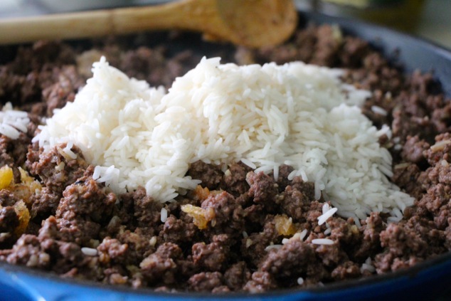 adding rice to the meat mixture