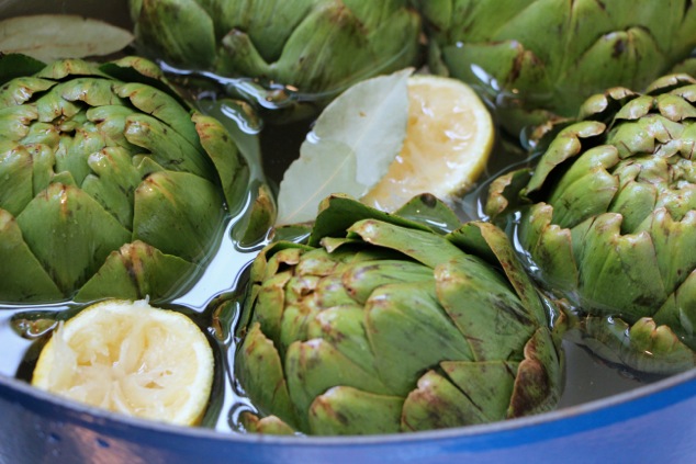 artichokes in pot with lemon water and bay leaf