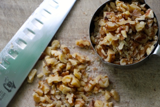 chopped walnuts in a measuring cup