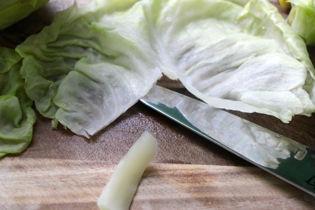 cutting out the middle stalk of the cabbage leaf