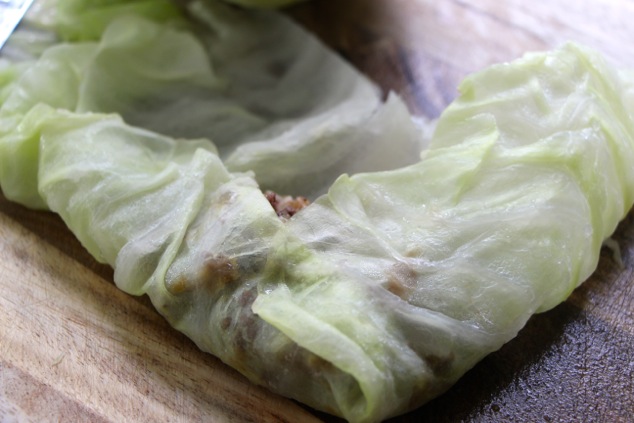 folding in the side of the cabbage leaf