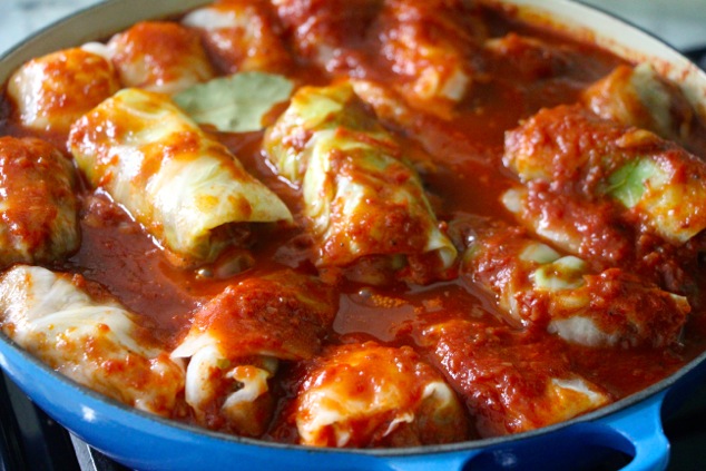 placing the staffed cabbage into the sauce