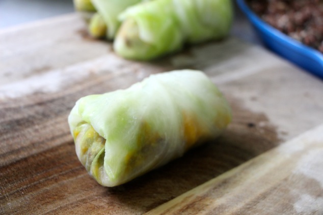 rolled cabbage leaf on a cutting board